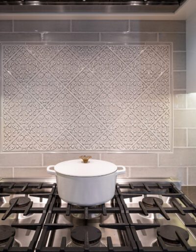 A kitchen with a stove and a backsplash.