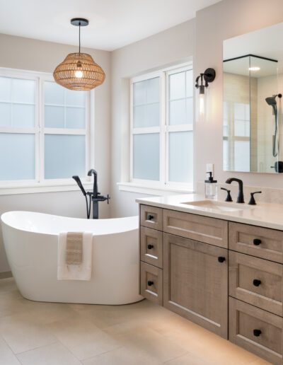 A bathroom with two sinks, a tub and a walk in shower.