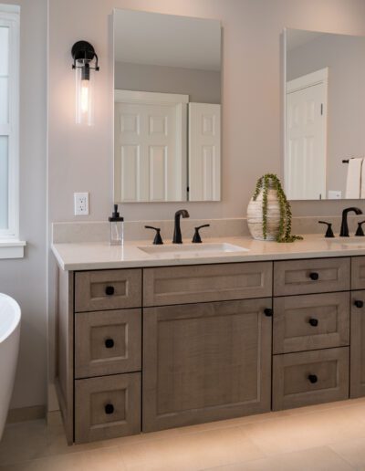 A bathroom with two sinks and a tub.