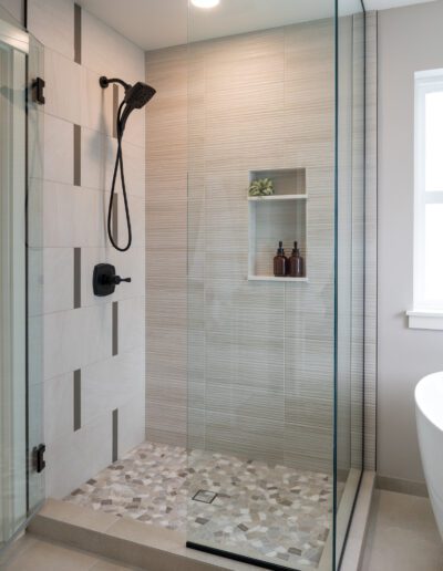 A modern bathroom with a glass shower stall.