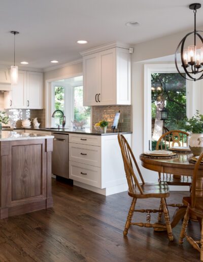 A kitchen with hardwood floors and a table and chairs.