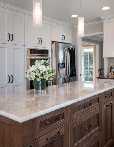 A kitchen with white cabinets and a center island.