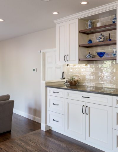 A living room with white cabinets and a fireplace.