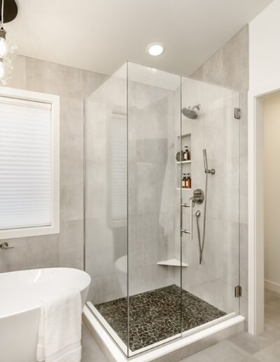 A modern bathroom with a glass shower stall.