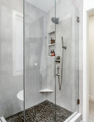 A modern bathroom with a glass shower stall.