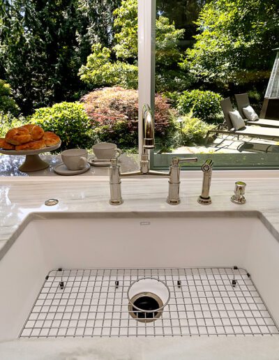 A sink in a kitchen with a window.